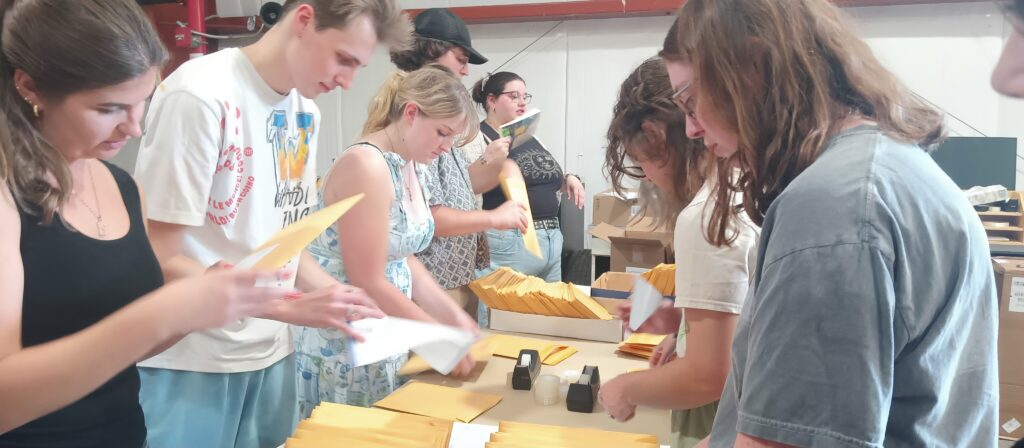 An assembly line of MAR staffmembers mailing an issue of MAR