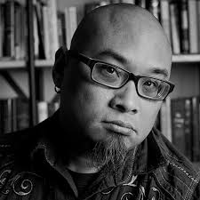 Black and white photo of man with glasses and goatee: Todd Kaneko