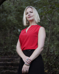 Jennifer Pullen, blond woman in red top, background of trees