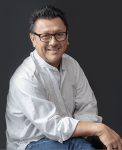 Photo of Juan Armando Rojas, a Mexican American man with dark hair and glasses